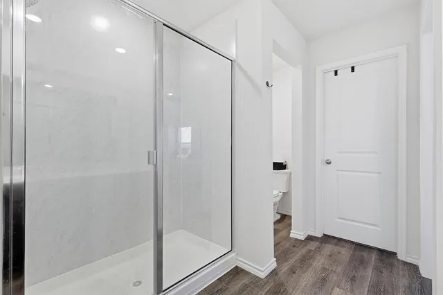a bathroom with a shower and a glass door