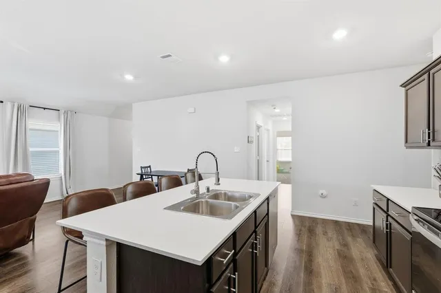 a kitchen with a sink a table and chairs
