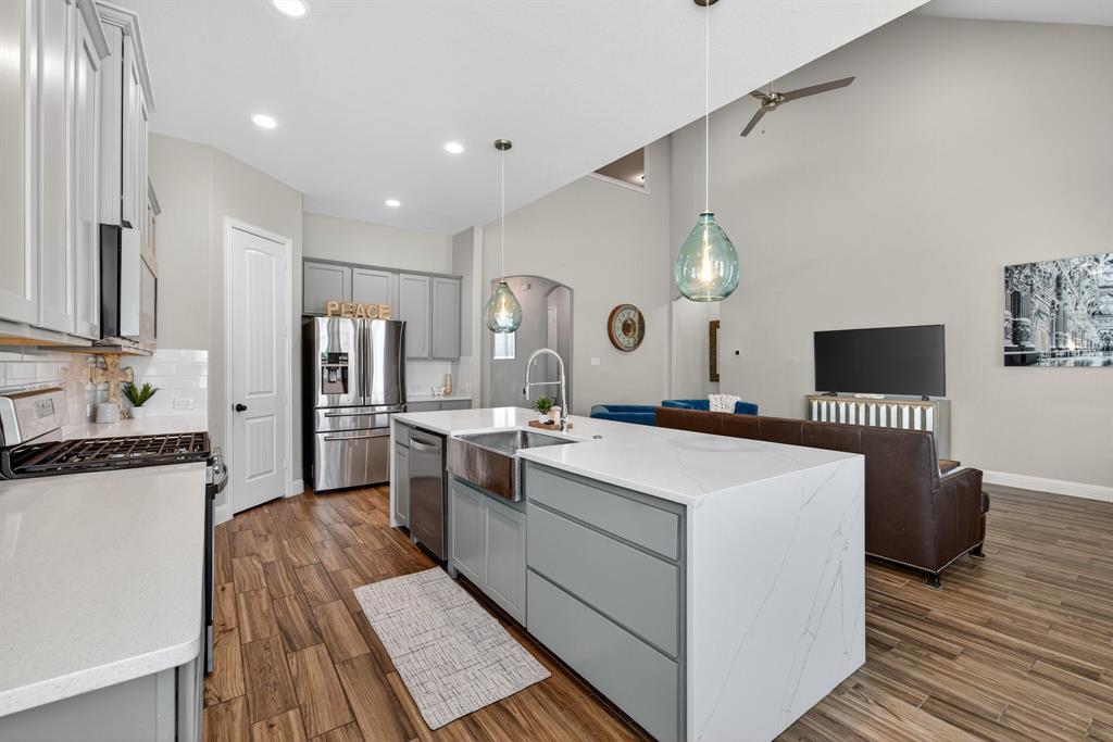 2815 Long Slope Road Arlington, TX 76001 - Photo 13 of 34 a kitchen that has a lot of cabinets and stainless steel appliances