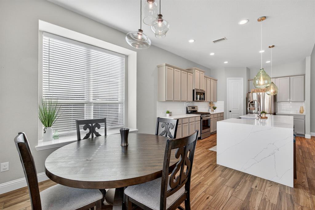 2815 Long Slope Road Arlington, TX 76001 - Photo 16 of 34 a kitchen with kitchen island a dining table and chairs