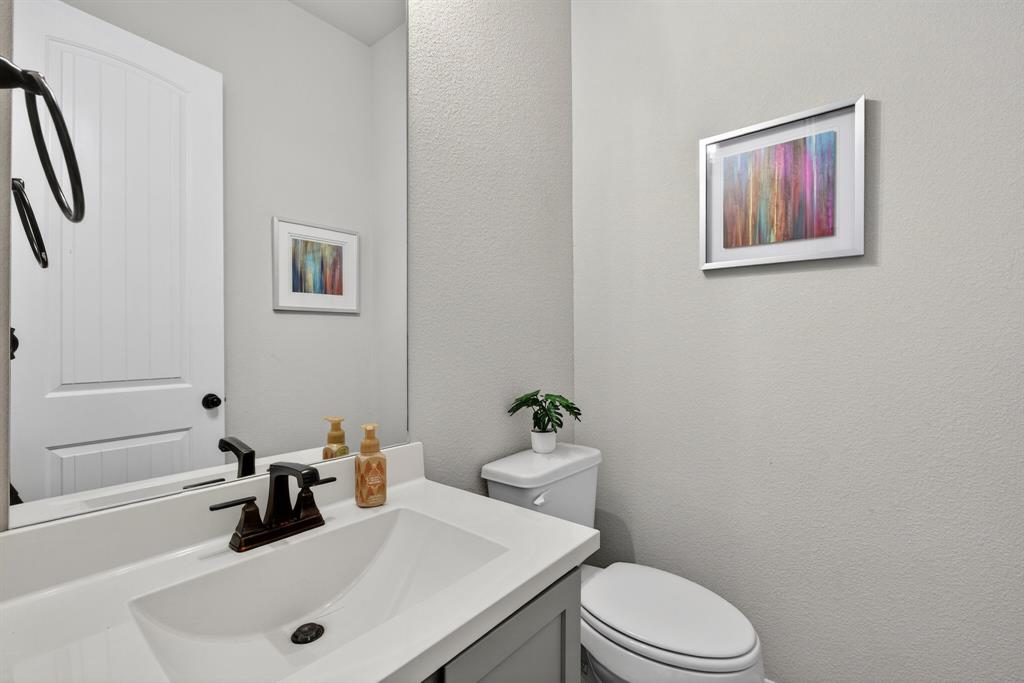 2815 Long Slope Road Arlington, TX 76001 - Photo 31 of 34 a bathroom with a sink mirror and toilet