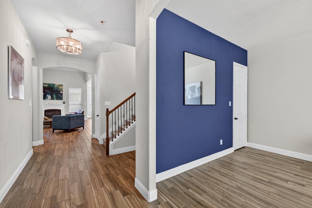 2815 Long Slope Road Arlington, TX 76001 - Photo 4 of 34 a view of a hallway to a livingroom with wooden floor and furniture