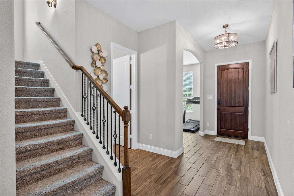2815 Long Slope Road Arlington, TX 76001 - Photo 7 of 34 a view of a hallway with wooden floor and staircase