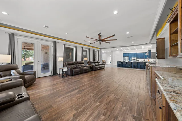 a view of living room with furniture and kitchen view