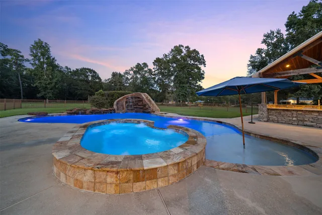 a view of a swimming pool with a yard