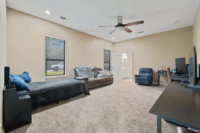 a bathroom with a granite countertop double vanity sink and a mirror