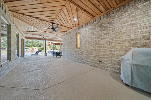 a view of a hall with wooden floor