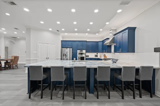 a kitchen with kitchen island a sink table and chairs