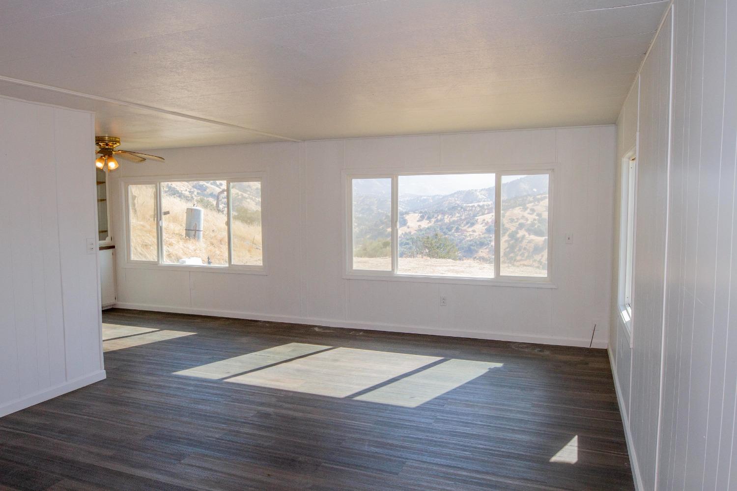 893 Winter Road Squaw Valley, CA 93675 - Photo 11 of 42 an empty room with wooden floor and windows