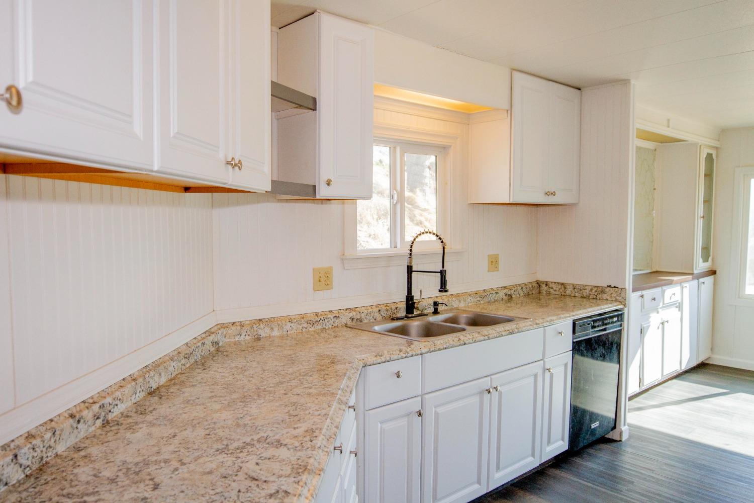 893 Winter Road Squaw Valley, CA 93675 - Photo 12 of 42 a kitchen with granite countertop white cabinets and white appliances