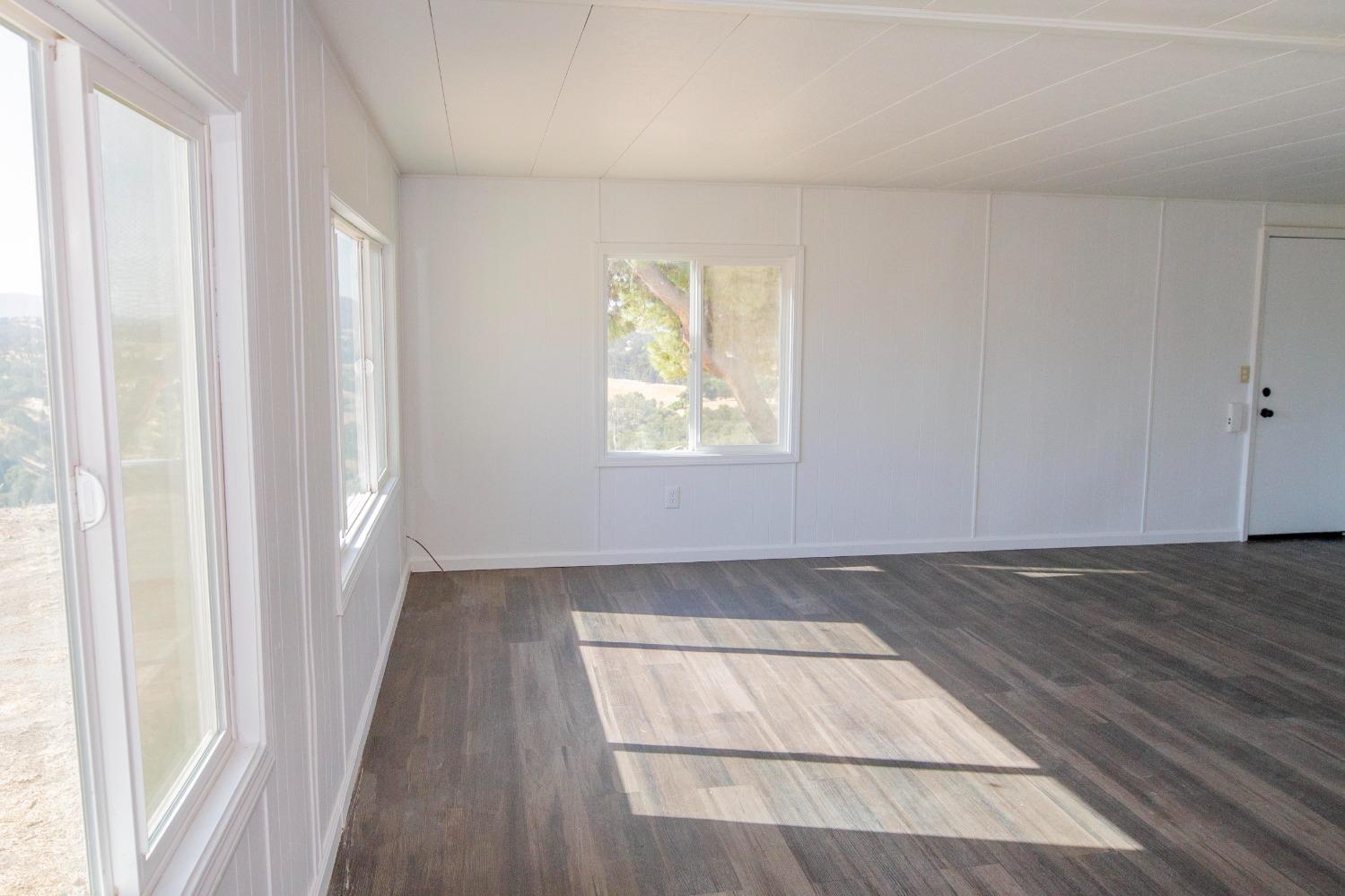 893 Winter Road Squaw Valley, CA 93675 - Photo 13 of 42 an empty room with wooden floor and windows
