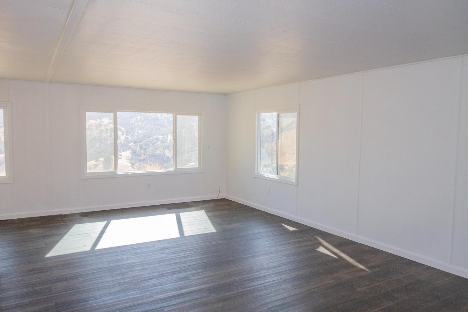 893 Winter Road Squaw Valley, CA 93675 - Photo 14 of 42 an empty room with wooden floor and windows