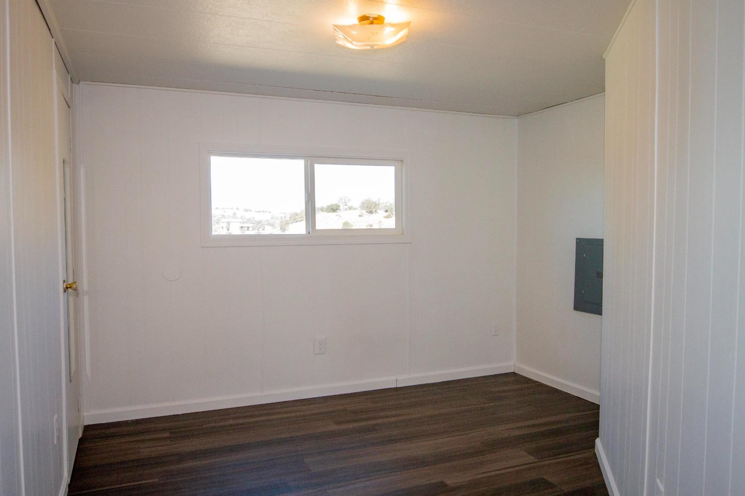 893 Winter Road Squaw Valley, CA 93675 - Photo 16 of 42 an empty room with wooden floor and windows