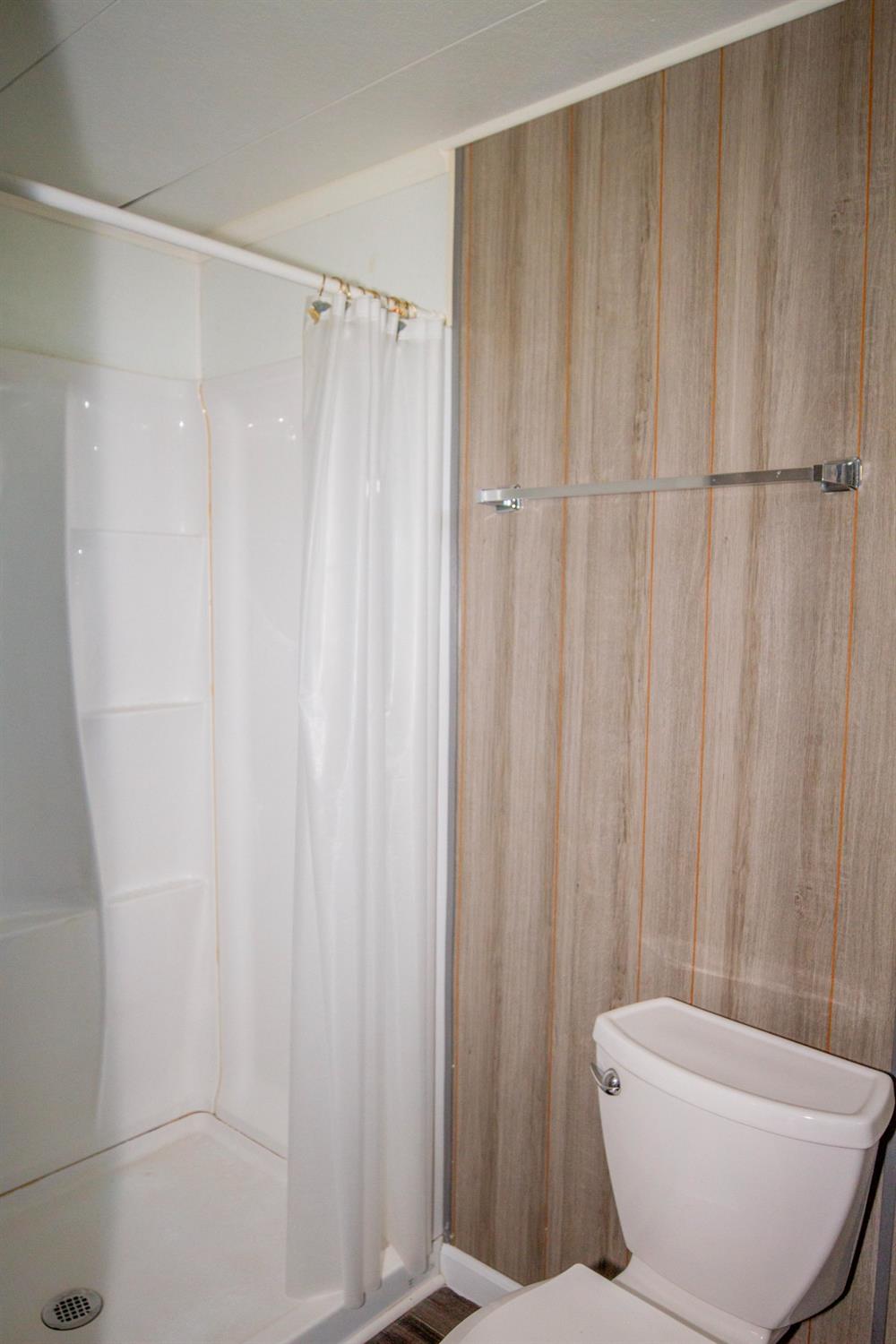 893 Winter Road Squaw Valley, CA 93675 - Photo 20 of 42 a bathroom with a shower curtain and a sink