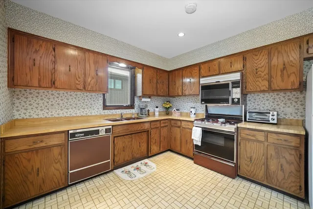 a bathroom with a granite countertop sink mirror and cabinets