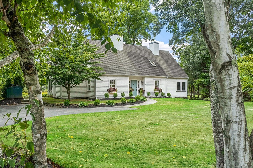 286 Lexington Road Concord, MA 01742 - Photo 1 of 41 a front view of a house with a garden and trees