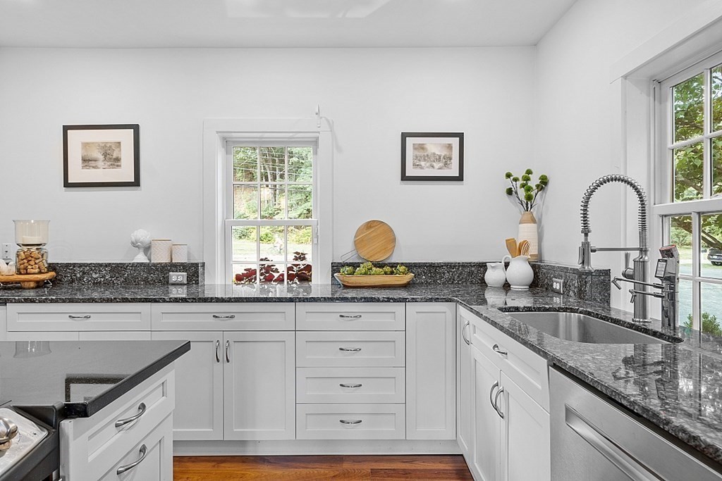 286 Lexington Road Concord, MA 01742 - Photo 19 of 41 a kitchen with granite countertop a sink stainless steel appliances and a window
