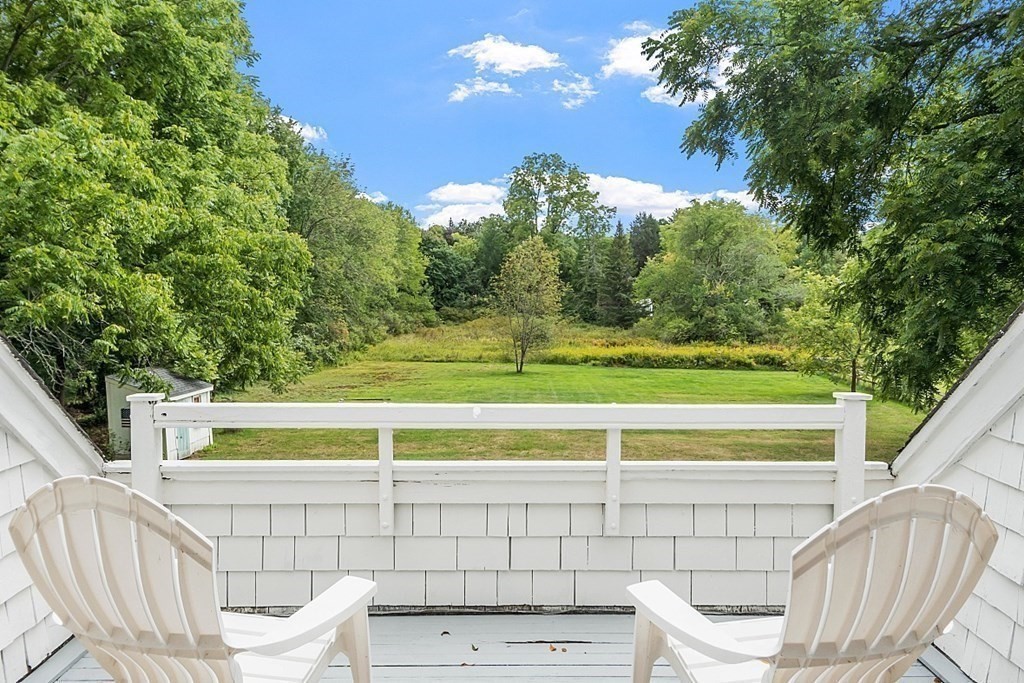 286 Lexington Road Concord, MA 01742 - Photo 31 of 41 a view of a chairs and table in the balcony