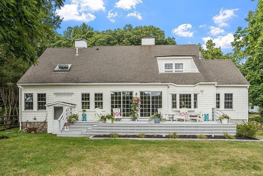 286 Lexington Road Concord, MA 01742 - Photo 35 of 41 a front view of a house with a garden and patio