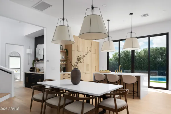 a dining room with furniture a chandelier and window