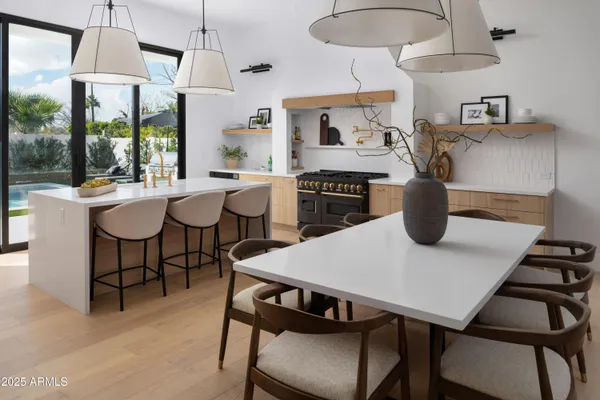 a kitchen with a dining table and chairs