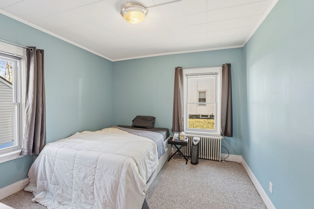 17 Cutler Street, Unit 1 Webster, MA 01570 - Photo 16 of 33 a bedroom with a bed and a window