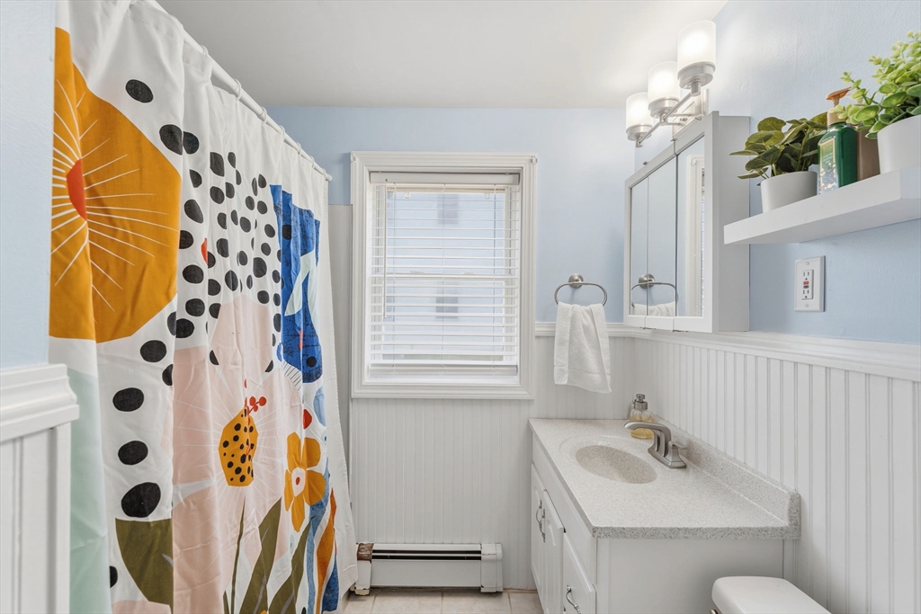 17 Cutler Street, Unit 1 Webster, MA 01570 - Photo 20 of 33 a bathroom with a sink a mirror and a shower curtain