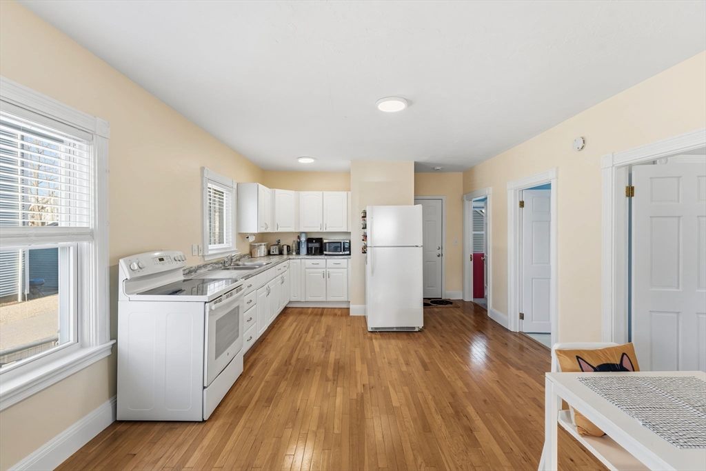 17 Cutler Street, Unit 1 Webster, MA 01570 - Photo 8 of 33 a kitchen with stainless steel appliances a refrigerator and a stove top oven
