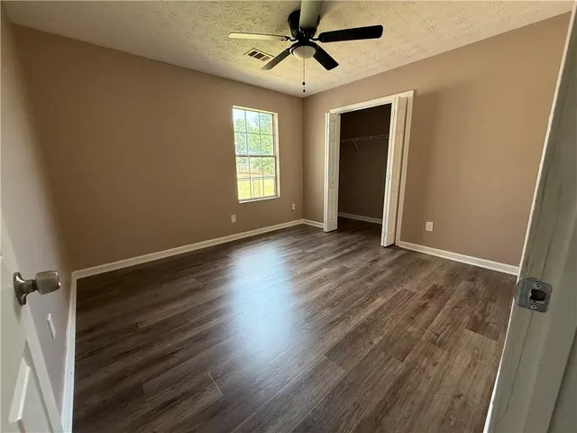 a view of room with window and wooden floor
