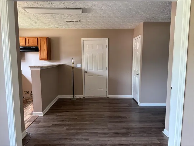 a view of a kitchen from the hallway