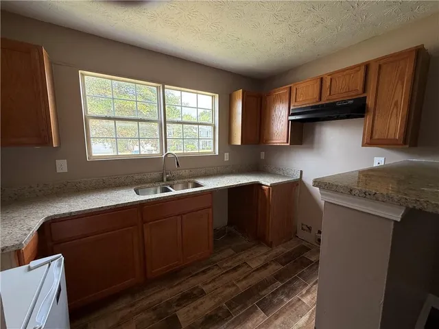 a kitchen with stainless steel appliances granite countertop a sink stove and cabinets