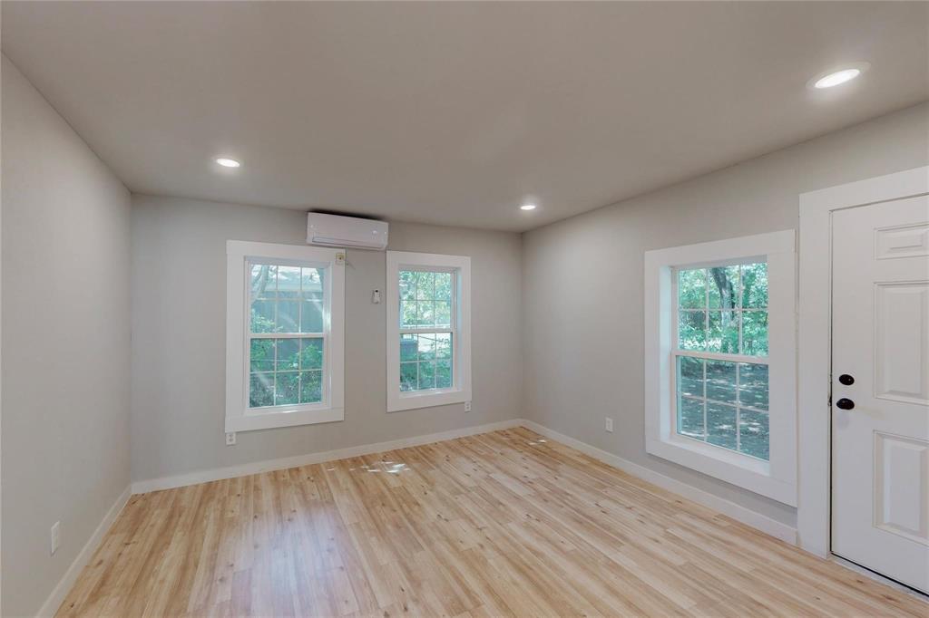 3603 York Street Dallas, TX 75210 - Photo 9 of 16 an empty room with wooden floor and windows