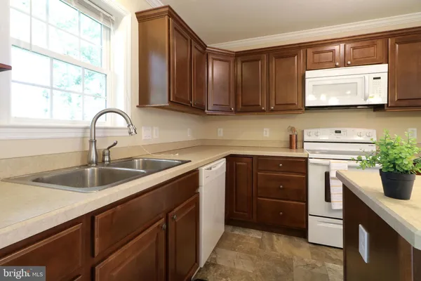 a kitchen with a sink cabinets and window