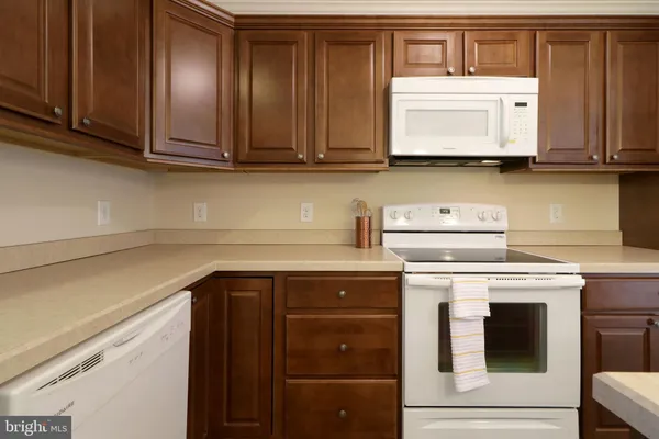 a kitchen with stainless steel appliances granite countertop a stove and a microwave