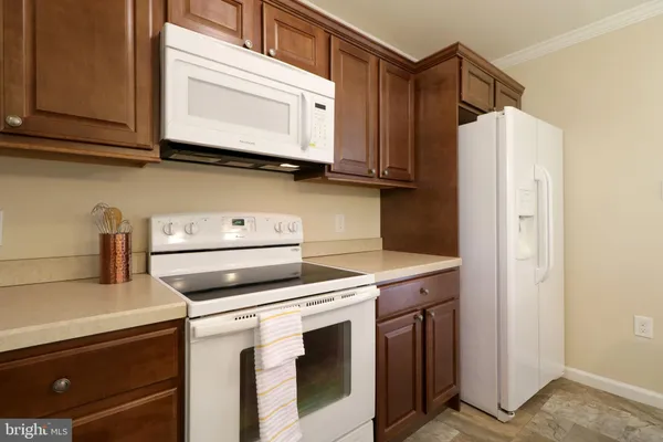 a kitchen with stainless steel appliances granite countertop a stove and a microwave