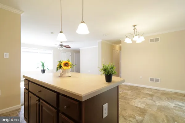a kitchen with sink cabinets and wooden floor