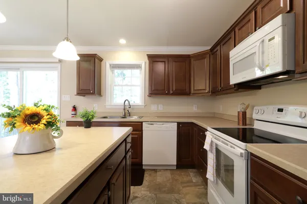 a kitchen with a sink a microwave and cabinets