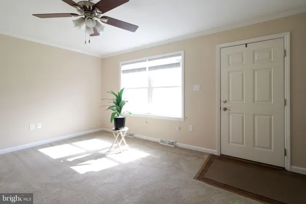 a view of a livingroom with a chandelier fan