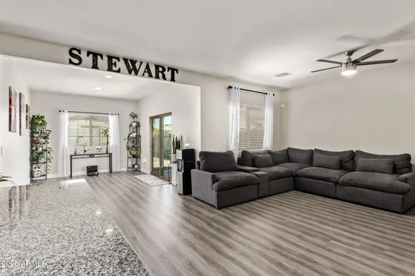 a living room with furniture and a wooden floor