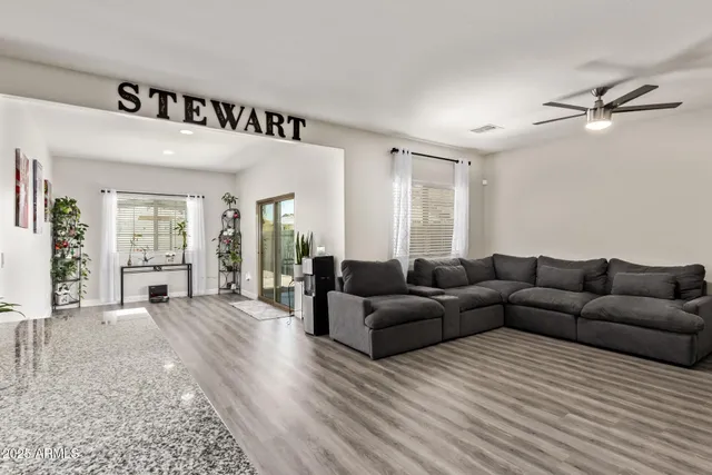 a living room with furniture and a wooden floor