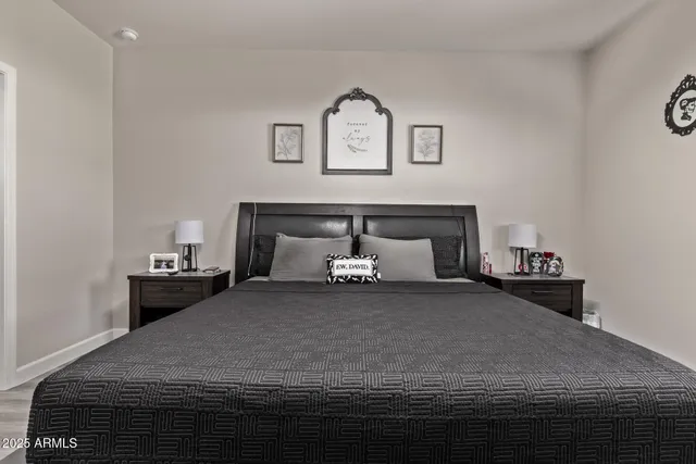 a bedroom with a bed and a night stand