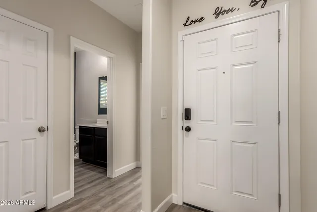 a view of a hallway with wooden floor
