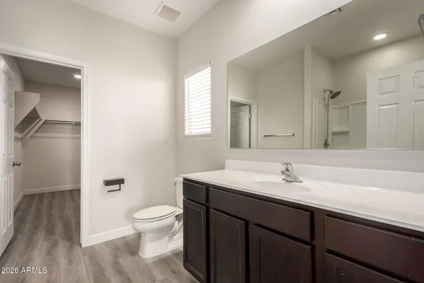 a bathroom with a sink a toilet and a large mirror