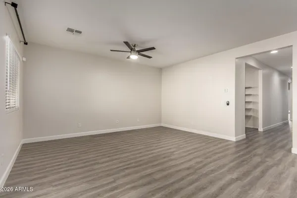 a view of an empty room with wooden floor