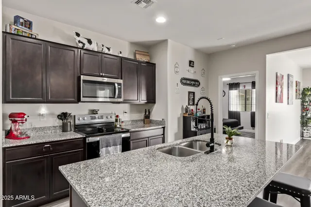a kitchen with a stove sink cabinets and refrigerator