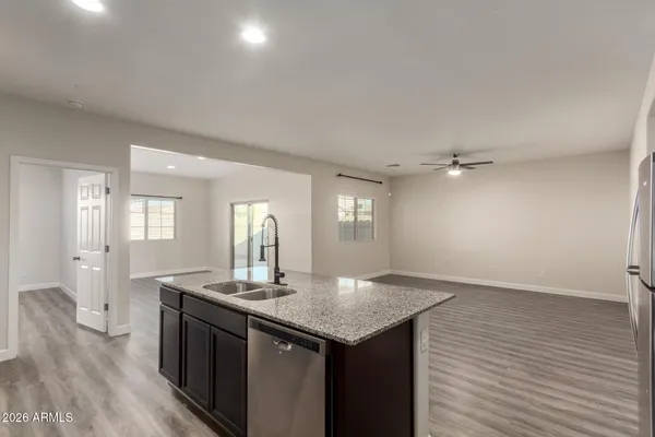 an empty room with wooden floor and mirror