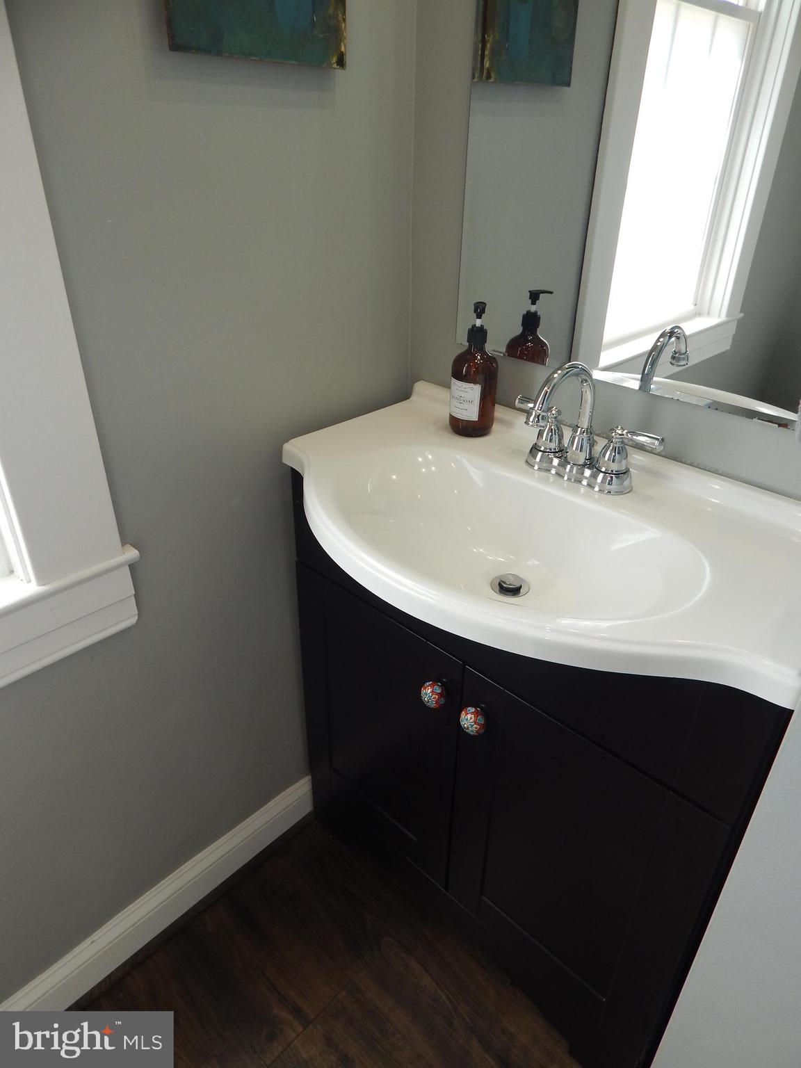 1002 Fawn Street Baltimore, MD 21202 - Photo 17 of 27 a bathroom with a sink and a mirror