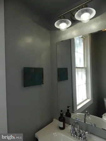 a bathroom with a toilet sink and mirror