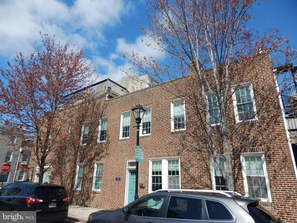 a front view of a residential apartment building with a yard