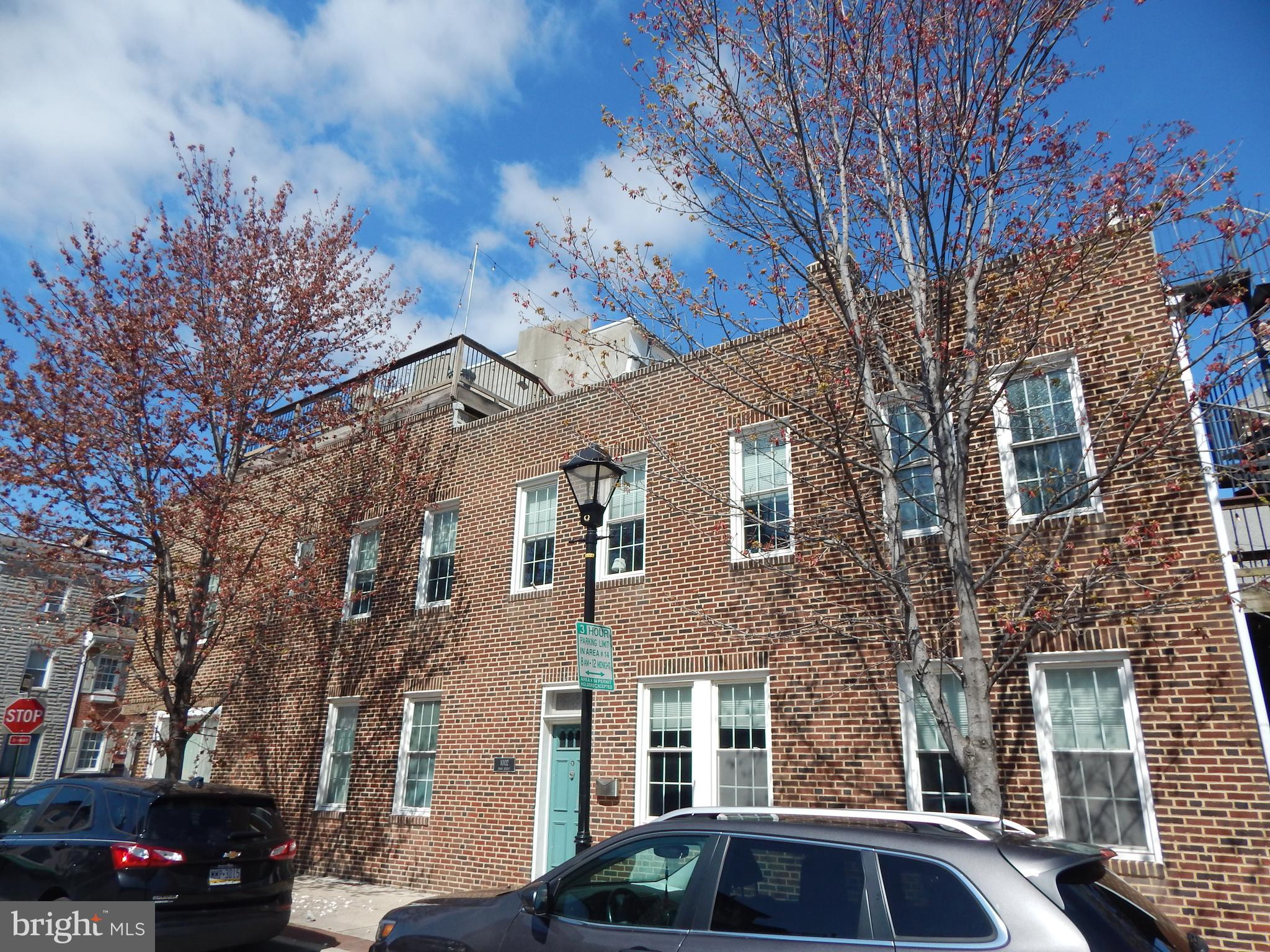 1002 Fawn Street Baltimore, MD 21202 - Photo 2 of 27 a front view of a residential apartment building with a yard